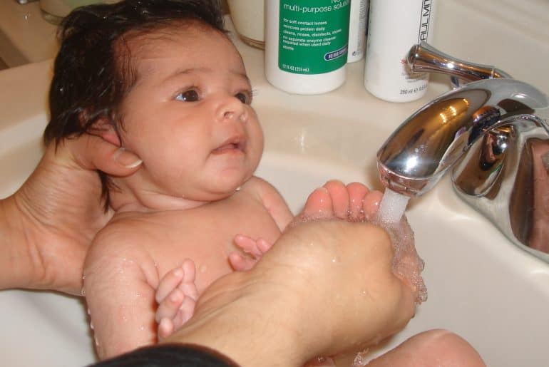 bathing newborn in sink