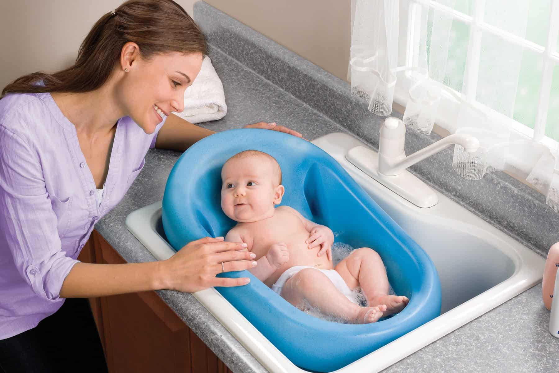 washing infant in kitchen sink