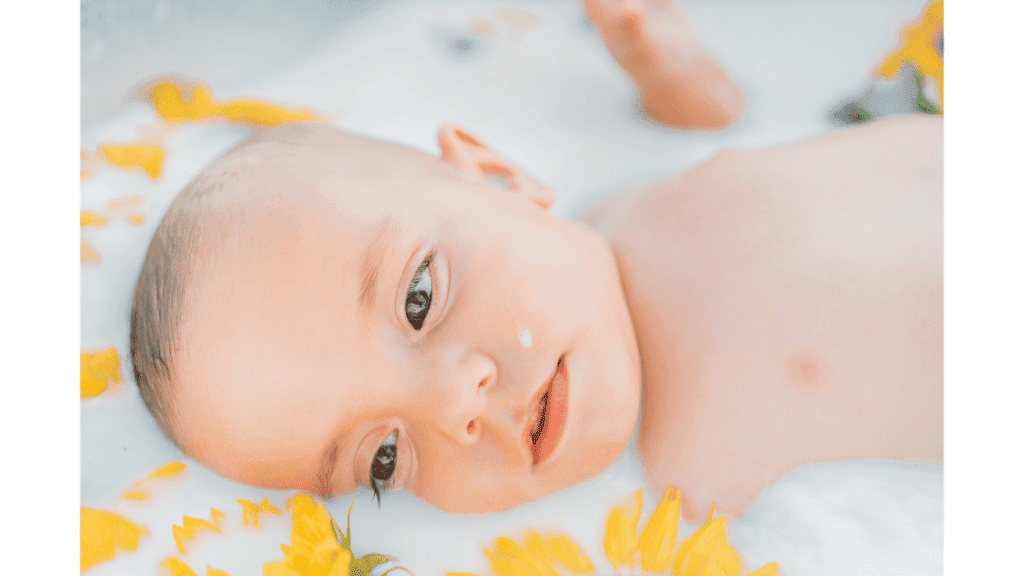 Baby-taking-milk-bath-with-flowers