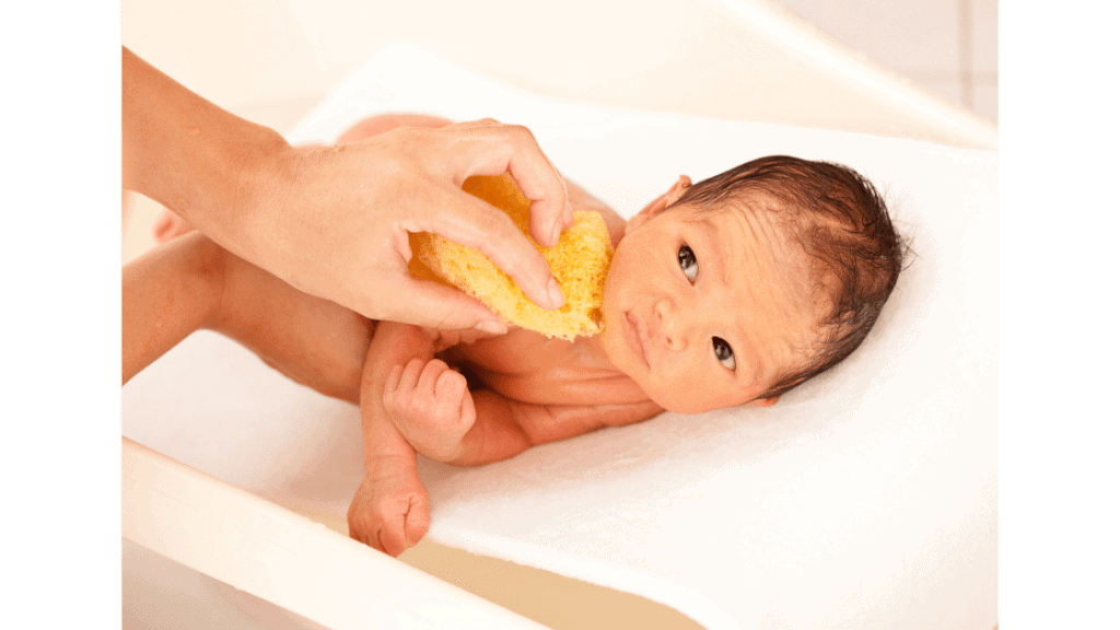 mother giving baby sponge bath after circumcision