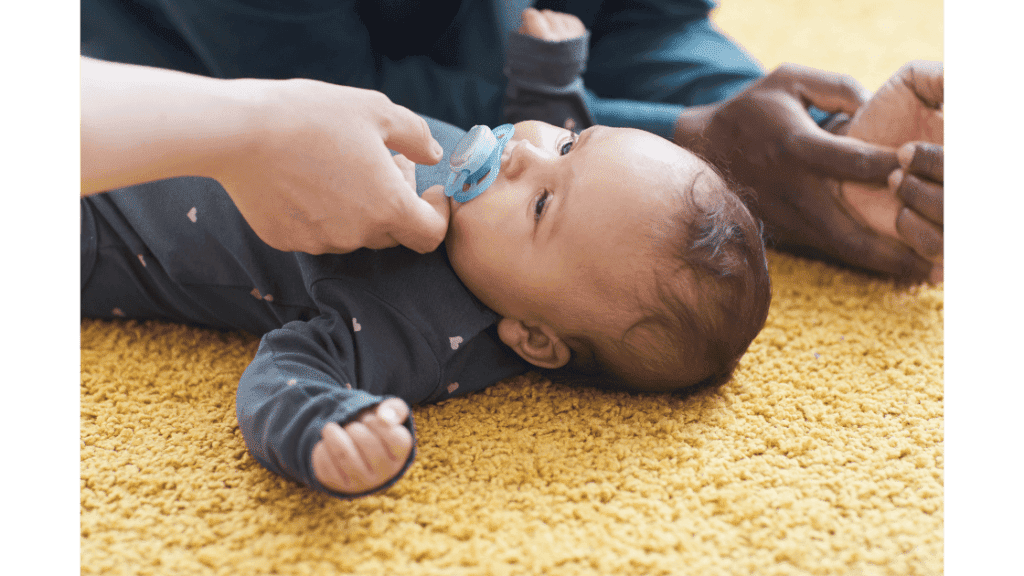 doctor giving baby a pacifier