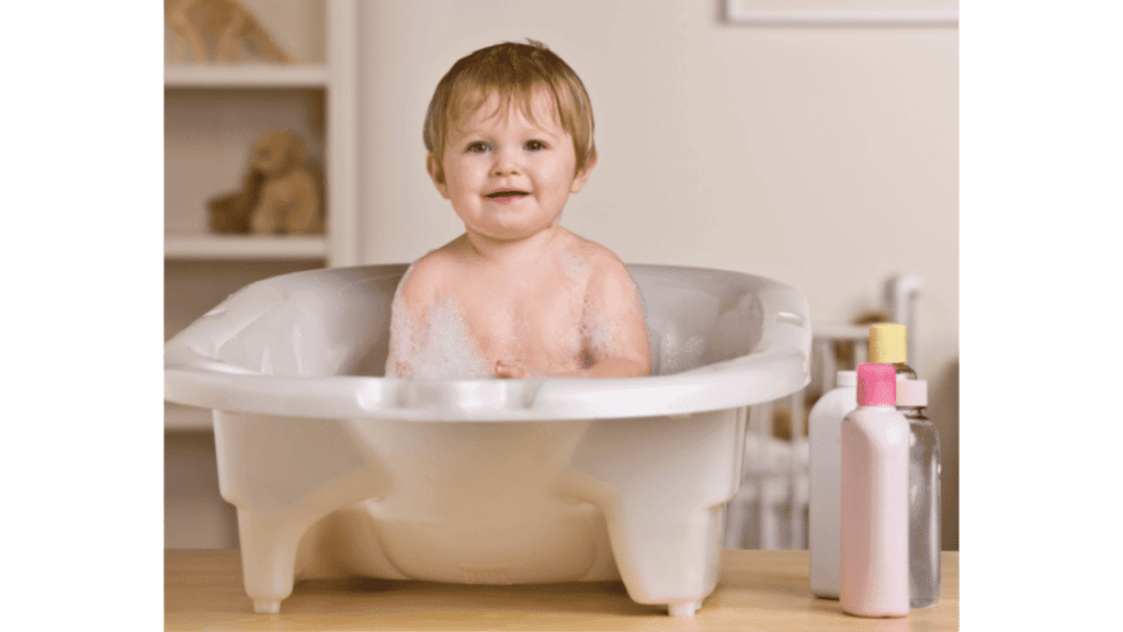 baby in bathtub with cleaning products